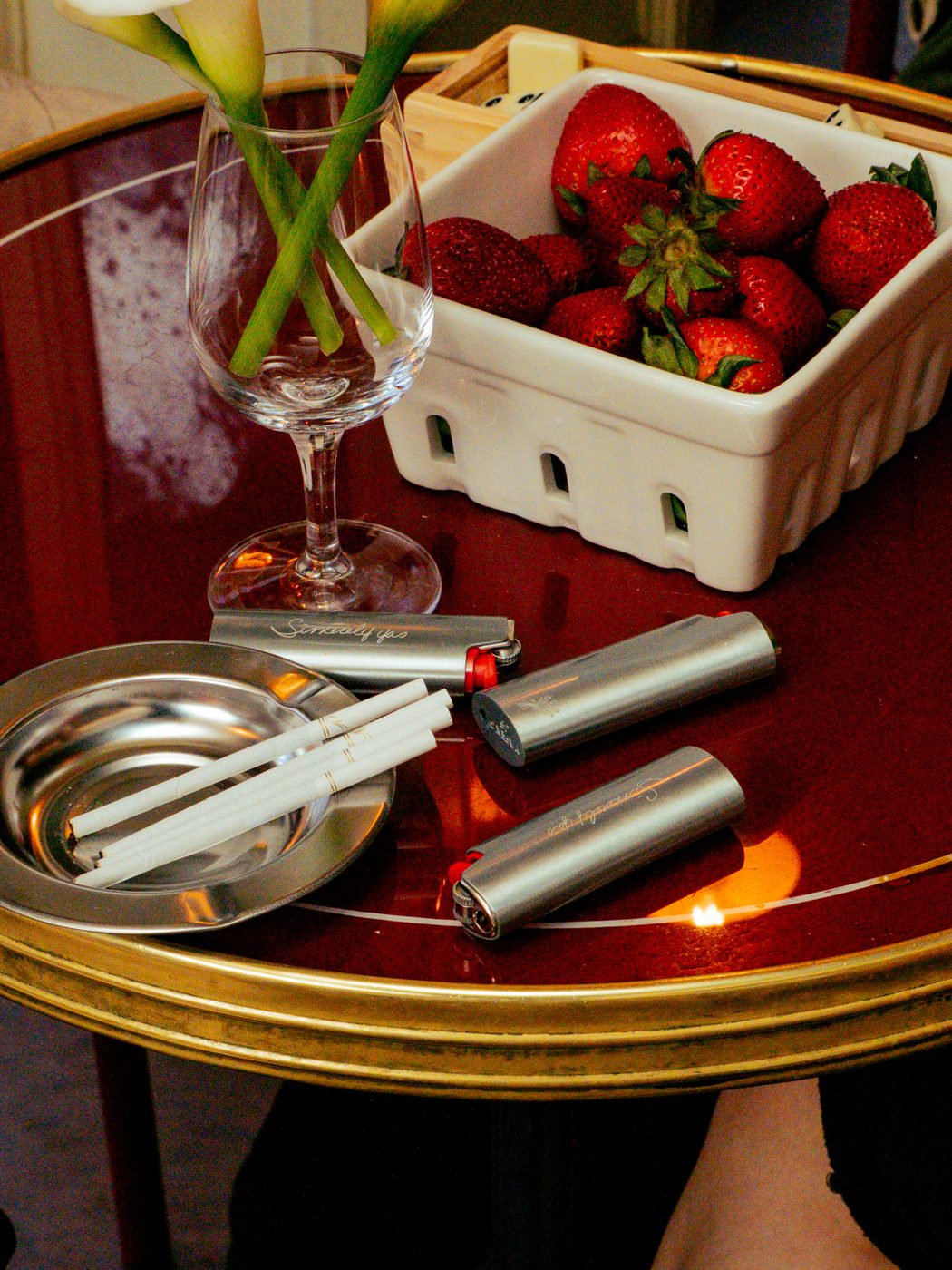 Sincerely Yas lighters on a red lacquer table